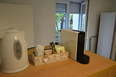 a kitchen counter with a microwave and a computer on it at The Bohemian Residence in Belgrade