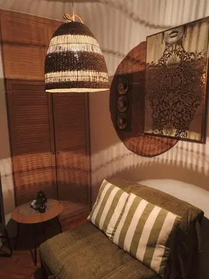 a living room with a couch and a lamp at Bella apartment in Belgrade