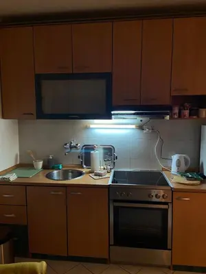 a kitchen with a sink and a stove at Bella apartment in Belgrade