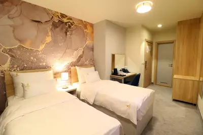 two beds in a hotel room with white sheets at Hotel Skadarlija NB in Belgrade
