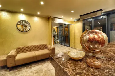 a living room with a couch and a clock on the wall at Hotel Skadarlija NB in Belgrade