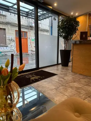 a room with a glass table with a window at Hotel Skadarlija NB in Belgrade