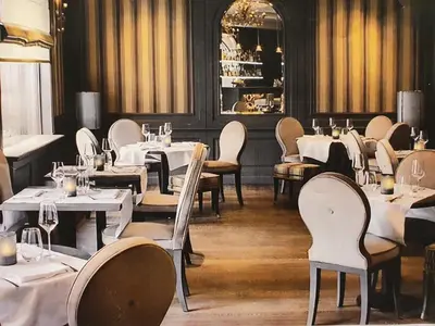 a dining room with white tables and chairs at Hotel Skadarlija NB in Belgrade