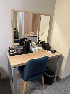 a desk with a blue chair and a mirror at Hotel Skadarlija NB in Belgrade