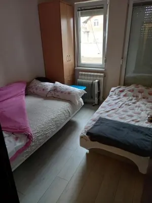 a bedroom with two beds and a window at Sofia Apartment 2 in Surčin