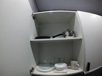a kitchen with a shelf with dishes and a sink at Sofia Apartment 2 in Surčin