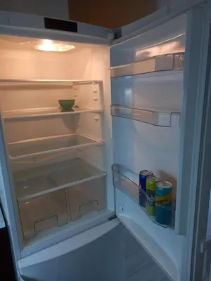 a refrigerator with its door open with drinks in it at Sofia Apartment 2 in Surčin