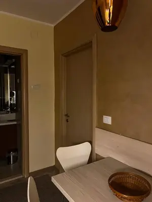 a dining room with a table and white chairs at Belgrade Pearl with free parking in Belgrade