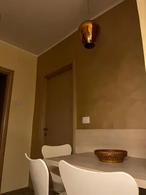 a dining room with a table and white chairs at Belgrade Pearl with free parking in Belgrade
