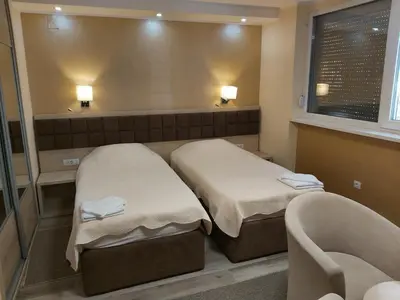a room with two beds and a mirror at Belgrade Pearl with free parking in Belgrade