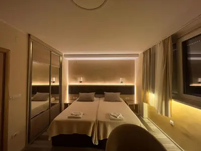a bedroom with a large bed and a mirror at Belgrade Pearl with free parking in Belgrade