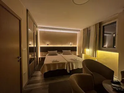 a hotel room with a bed and a chair at Belgrade Pearl with free parking in Belgrade