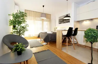 a living room with a table and a dining room at Apartment SUN CITY 2 in Belgrade