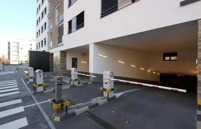 a row of parking meters in front of a building at Apartment SUN CITY 2 in Belgrade