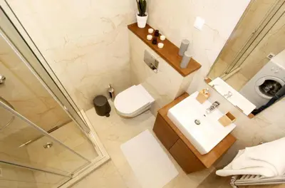 a bathroom with a toilet and a sink and a shower at Apartment SUN CITY 2 in Belgrade