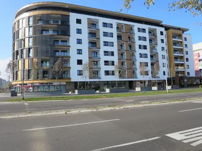 a large apartment building on the side of a street at Apartment SUN CITY 1 in Belgrade