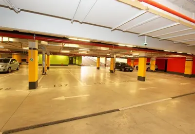 an empty parking garage with cars parked in it at Apartment SUN CITY 1 in Belgrade