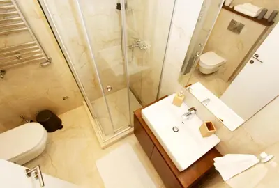 a bathroom with a shower and a sink and a toilet at Apartment SUN CITY 1 in Belgrade
