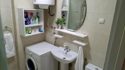 a bathroom with a sink and a washing machine at Savinac apartman u srcu Beograda, Trg Slavija in Belgrade