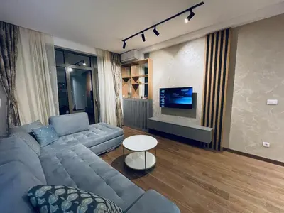 a living room with a couch and a tv at Arcadia 22 Belgrade Waterfront in Belgrade