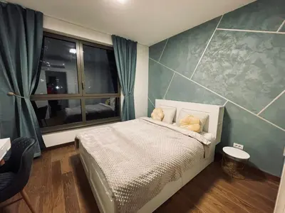 a small bedroom with a bed and a window at Arcadia 22 Belgrade Waterfront in Belgrade