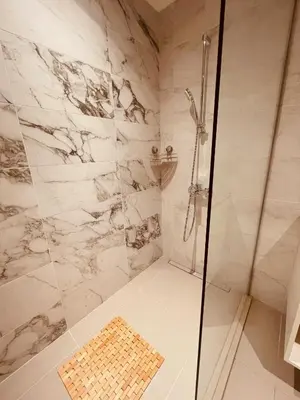 a bathroom with a shower with a glass door at Arcadia 22 Belgrade Waterfront in Belgrade