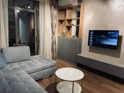 a living room with a couch and a flat screen tv at Arcadia 22 Belgrade Waterfront in Belgrade