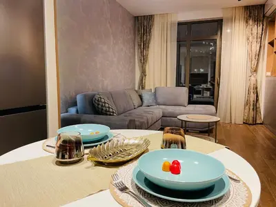 a living room with a table with plates on it at Arcadia 22 Belgrade Waterfront in Belgrade