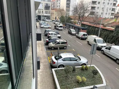 a view from a window of a parking lot with cars at Downtown in Belgrade