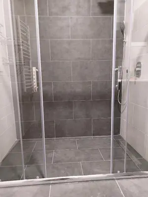 a shower with a glass door in a bathroom at Jež in Belgrade