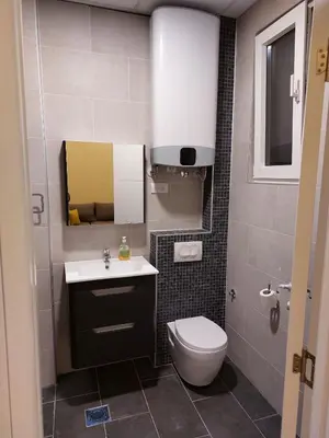 a small bathroom with a toilet and a sink at Jež in Belgrade