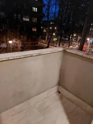 an empty room with a window at night at Jež in Belgrade