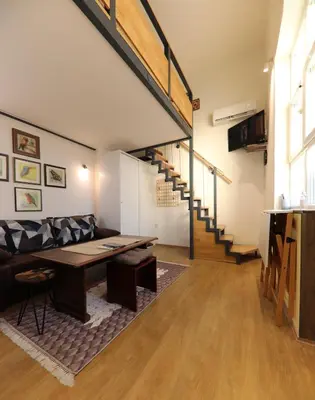 a living room with a couch and a table at Central Ant Apartment in Belgrade