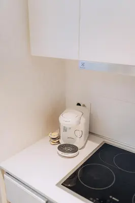 a kitchen with a stove and a toaster on a counter at Beograd na vodi - BW ViSTA LUXURY in Belgrade