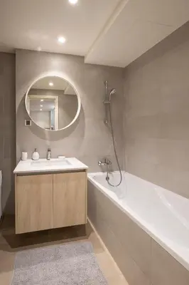 a bathroom with a sink and a tub and a mirror at Beograd na vodi - BW ViSTA LUXURY in Belgrade