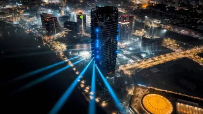 a view of a city at night with blue lights at Beograd na vodi - BW ViSTA LUXURY in Belgrade