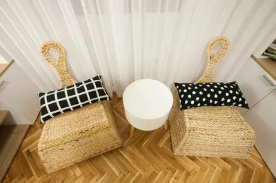 two wicker chairs and a table in a room at Studio 10 in Belgrade