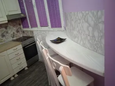 a small kitchen with a table and two chairs at Bajloni lux in Belgrade