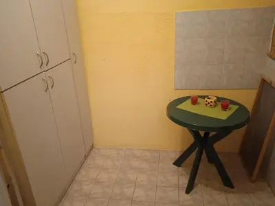 a small green table in a corner of a kitchen at Bajloni lux in Belgrade