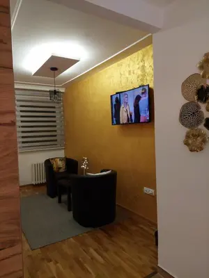 a waiting room with chairs and a tv on the wall at Room 23 in Belgrade