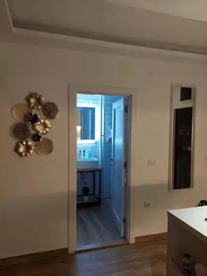 a kitchen with a door leading to a bathroom at Room 23 in Belgrade