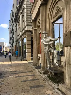 a statue of a baseball player is on the side of a building at Central location for you in Belgrade