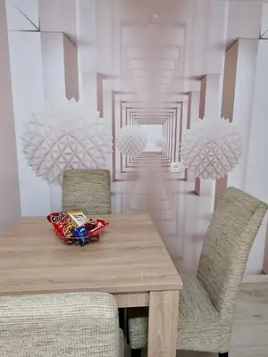 a dining room with a wooden table and chairs at Central location for you in Belgrade