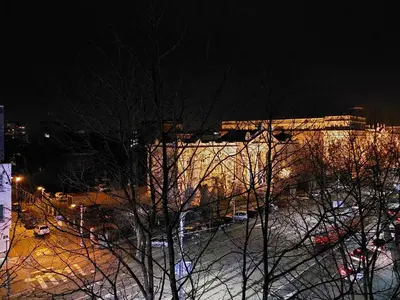 a building at night with snow on the ground at Boulevards apartment in Belgrade