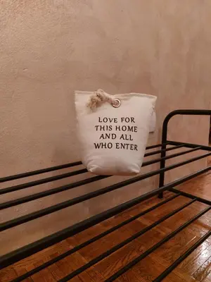 a pillow that says love for this home and all who enter at Boulevards apartment in Belgrade