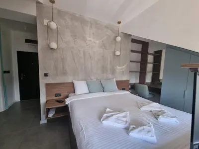 a bedroom with a large white bed with two pillows at Parliament View Apartments in Belgrade
