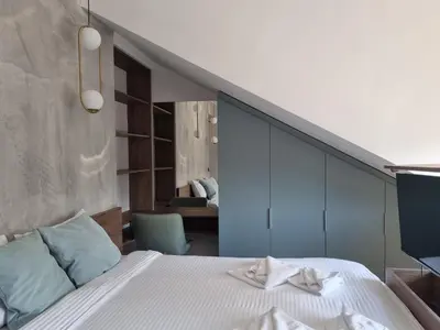 a bedroom with a bed with a blue wall at Parliament View Apartments in Belgrade