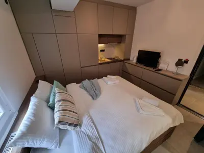 a large white bed with two pillows on it at Parliament View Apartments in Belgrade