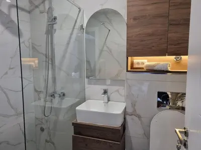 a bathroom with a sink and a shower at Parliament View Apartments in Belgrade