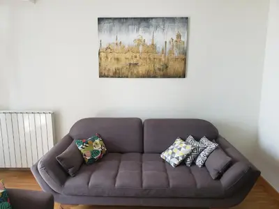 a brown couch in a living room with pillows on it at B-G Waterfront Apartment in Belgrade